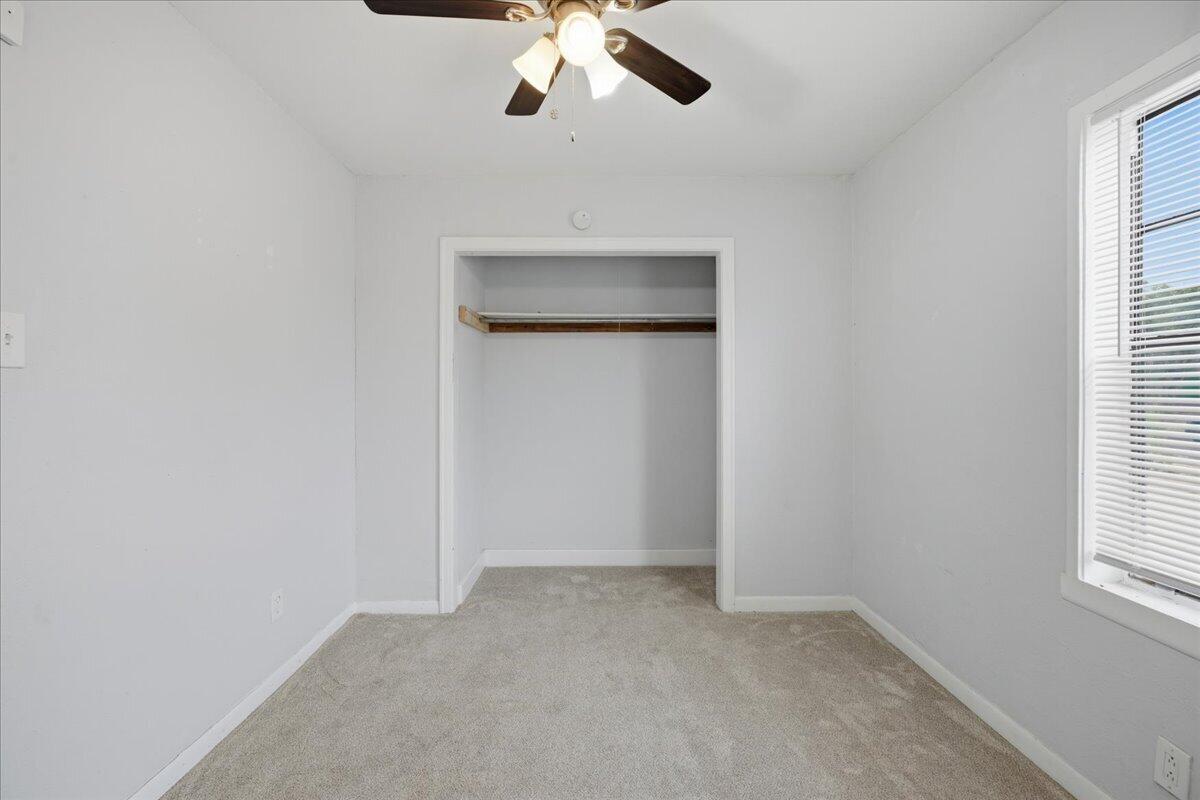 2503 30th Street Lubbock, TX 79410 - Photo 21 of 26 an empty room with a window and a ceiling fan