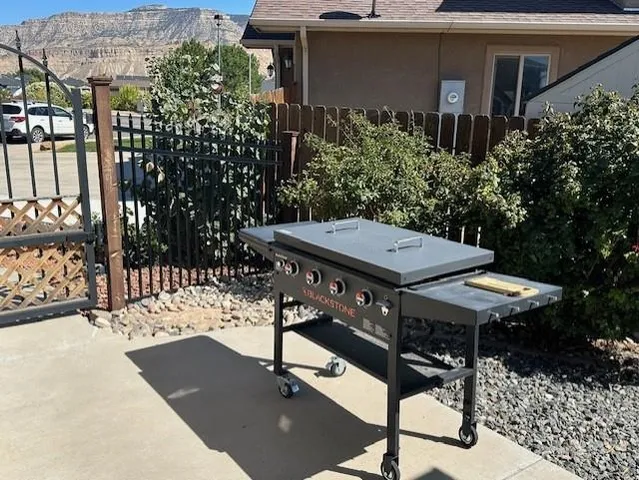 a view of a patio with table and chairs and potted plants