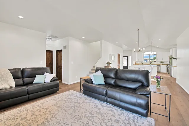 a living room with furniture and a chandelier