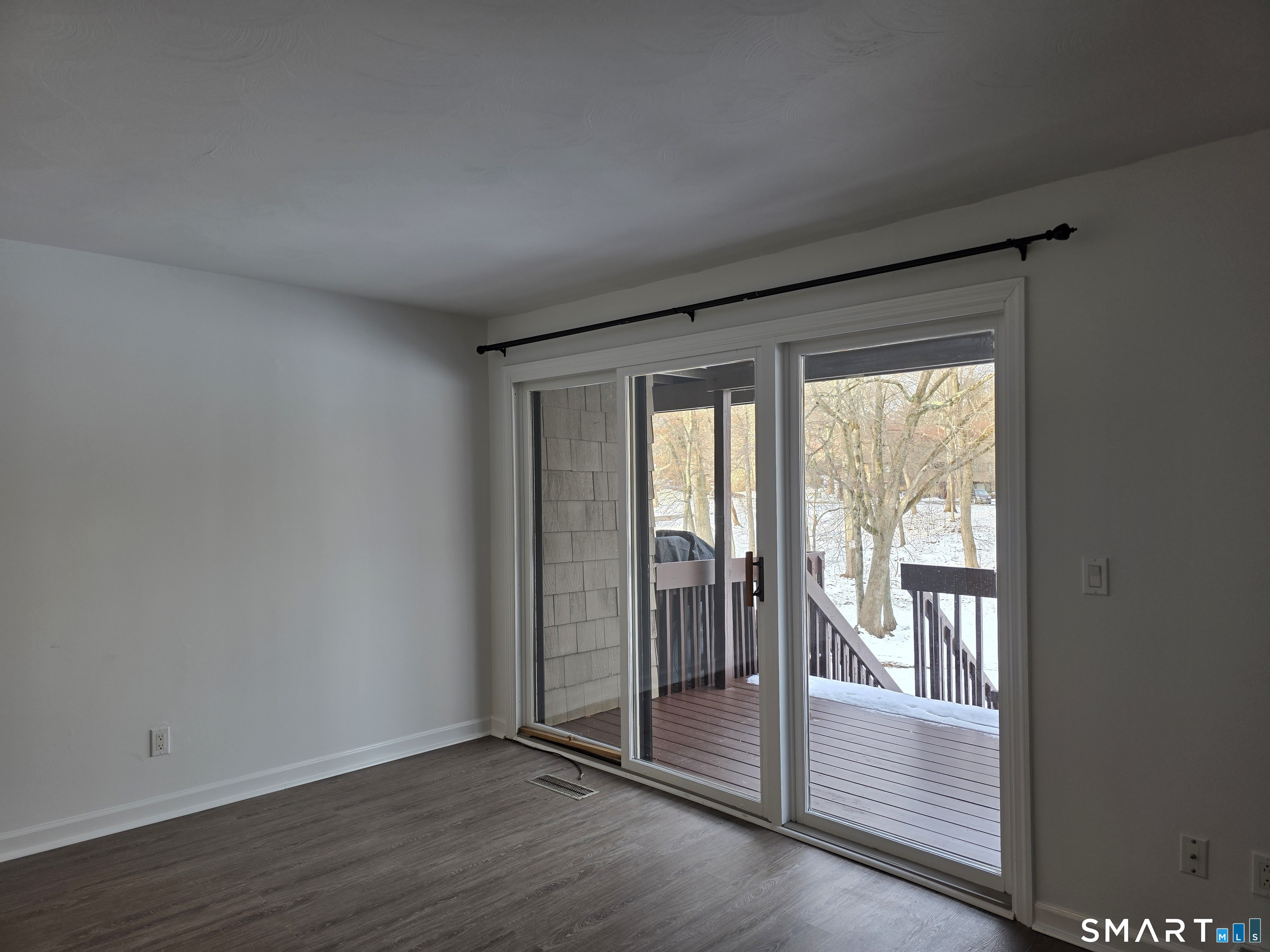 45 Towne House Road, Unit 45 Hamden, CT 06514 - Photo 11 of 23 a view of an empty room with wooden floor and a window