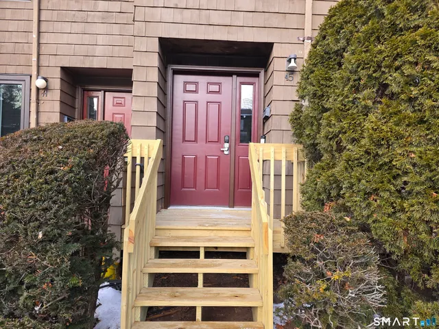 a view of front door of house with stairs