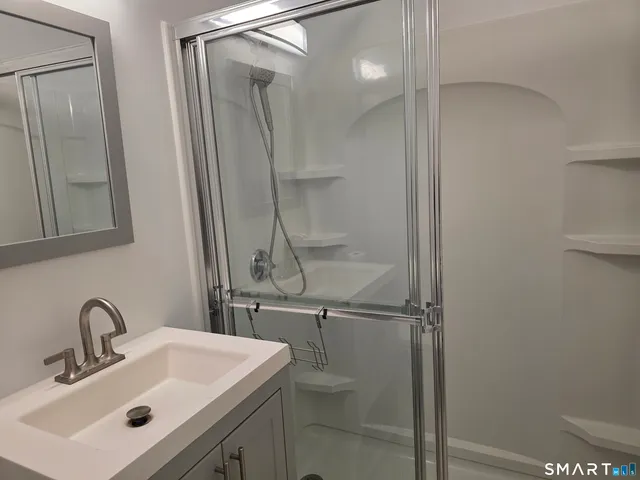 a bathroom with a sink toilet and shower