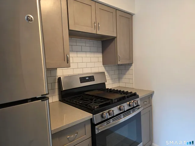 a stove top oven sitting inside of a kitchen