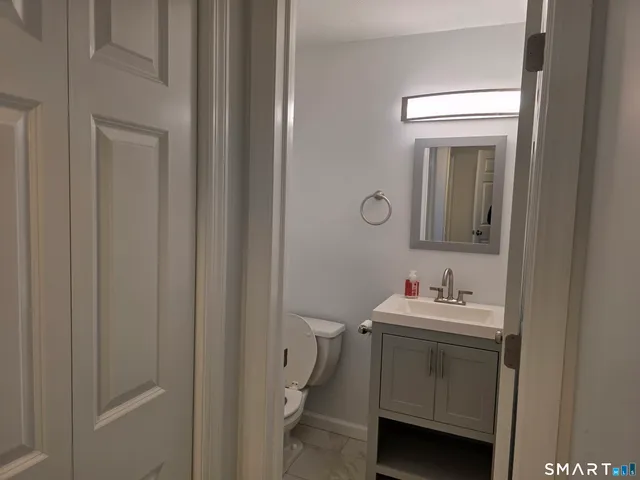a bathroom with a sink toilet and mirror