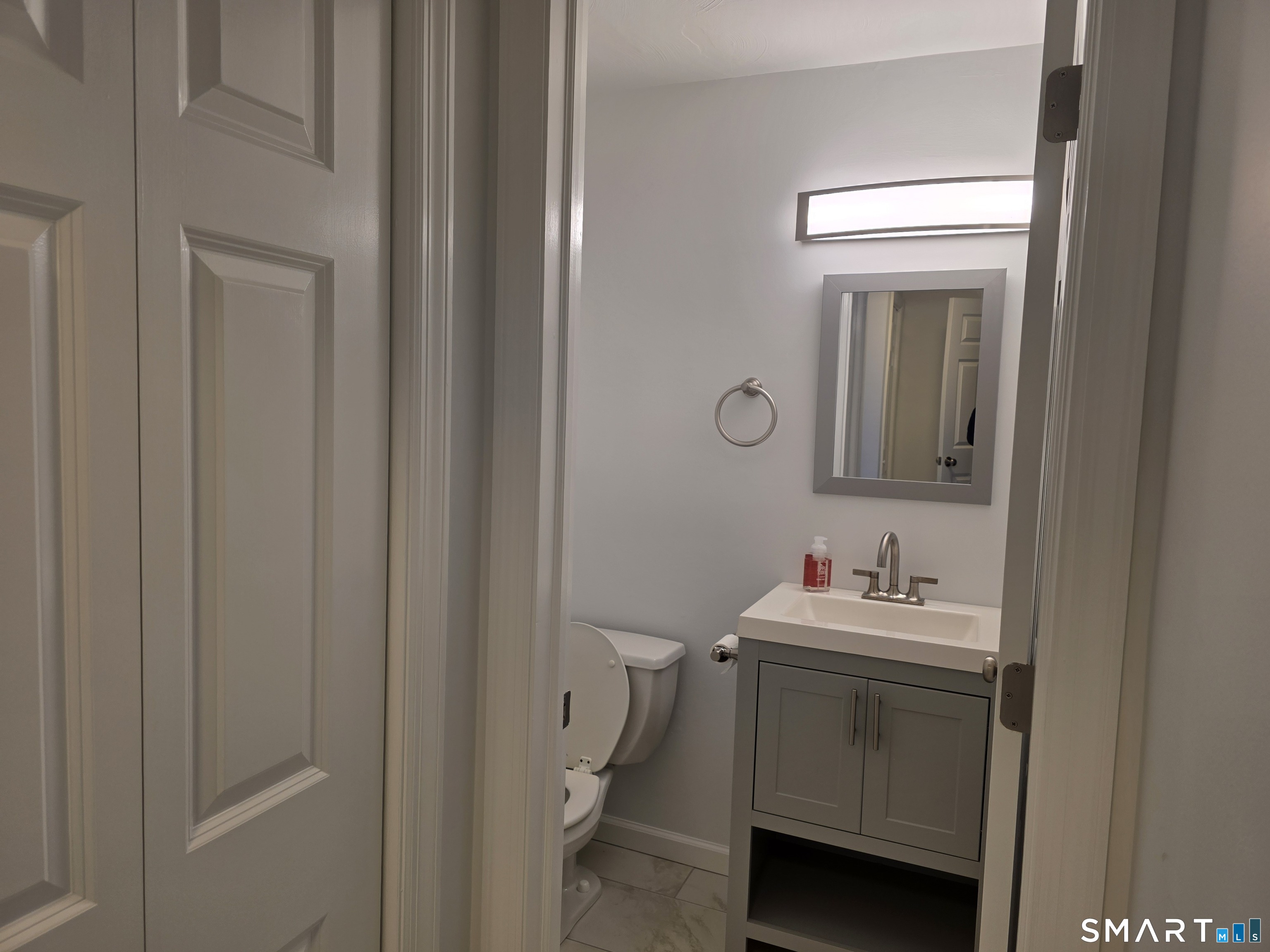 45 Towne House Road, Unit 45 Hamden, CT 06514 - Photo 8 of 23 a bathroom with a sink toilet and mirror