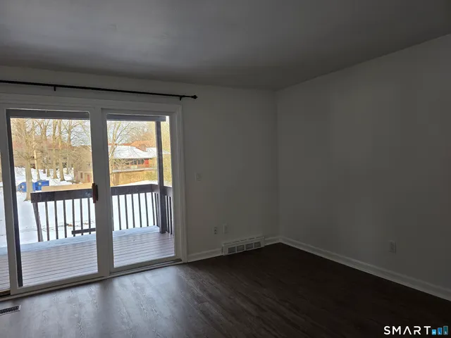 a view of wooden floor and windows in a room
