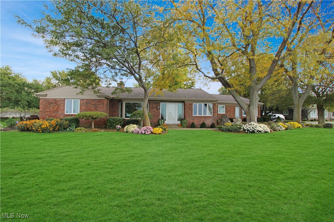 4520 East Cliff Road Port Clinton, OH 43452 - Photo 4 of 50 Ranch-style house with a front yard, brick siding, and a chimney