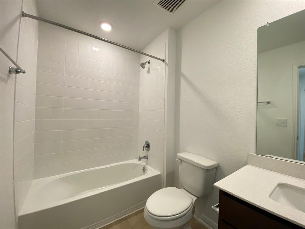 225 Saide Street Georgetown, TX 78626 - Photo 17 of 22 a white toilet sitting next to a bath tub