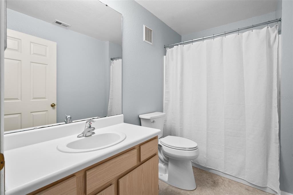 5459 Vineland Road, Unit 4302 Orlando, FL 32811 - Photo 11 of 25 a bathroom with a sink toilet and a mirror