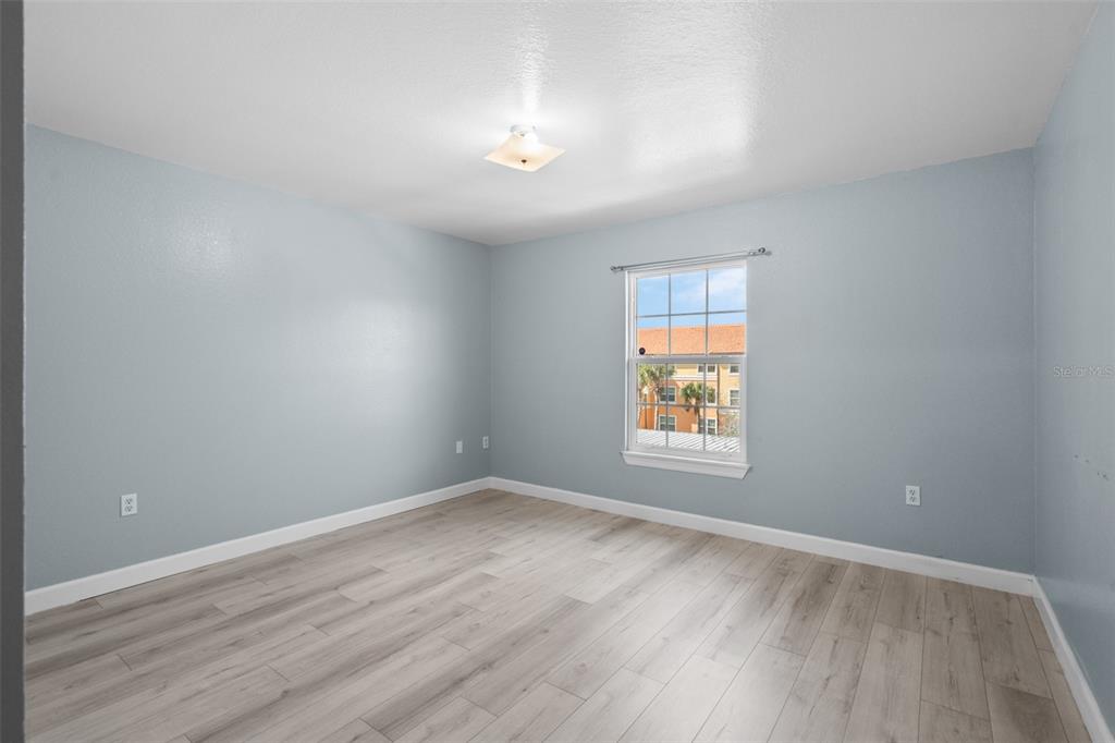 5459 Vineland Road, Unit 4302 Orlando, FL 32811 - Photo 16 of 25 wooden floor in an empty room with a window