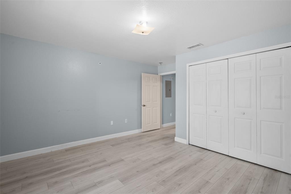 5459 Vineland Road, Unit 4302 Orlando, FL 32811 - Photo 17 of 25 a view of an empty room with wooden floor