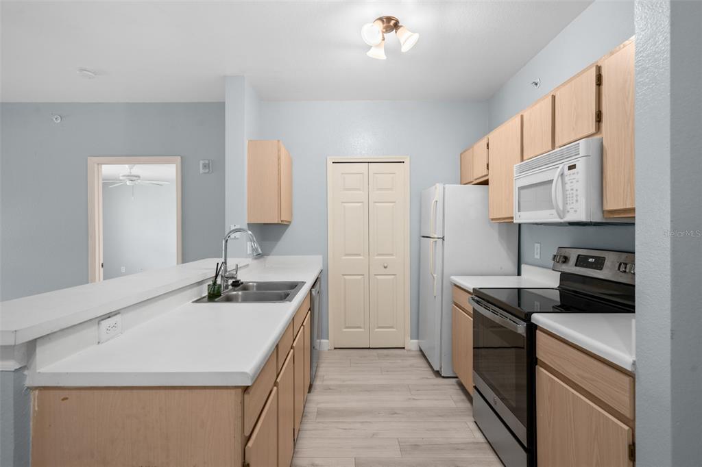 5459 Vineland Road, Unit 4302 Orlando, FL 32811 - Photo 3 of 25 a kitchen with stainless steel appliances granite countertop a sink stove and refrigerator