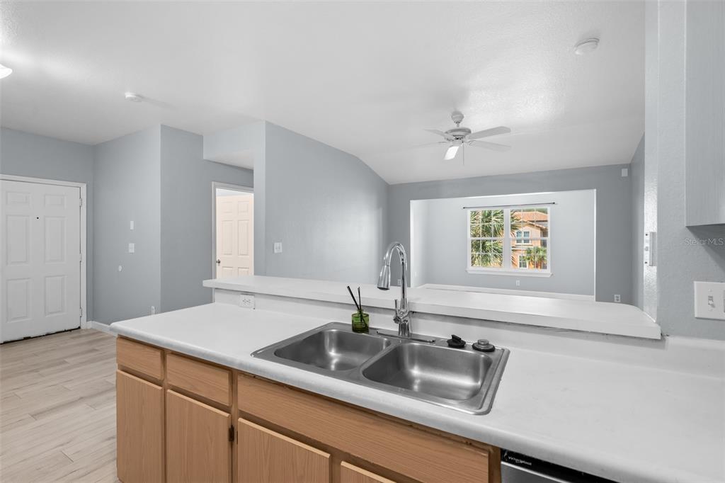 5459 Vineland Road, Unit 4302 Orlando, FL 32811 - Photo 5 of 25 a kitchen with a sink and a window