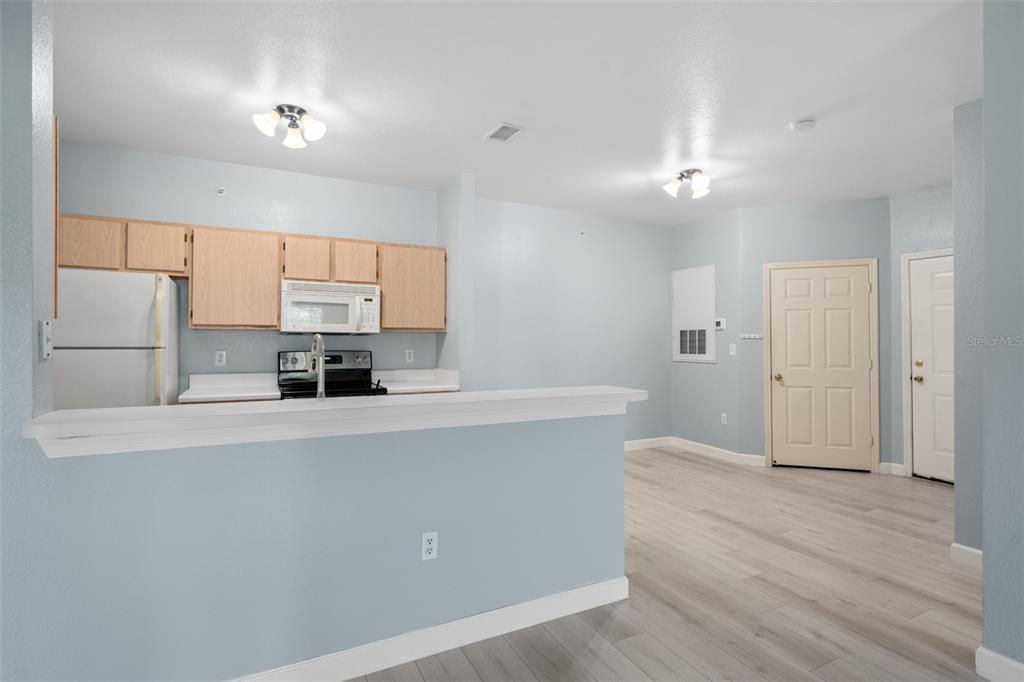 5459 Vineland Road, Unit 4302 Orlando, FL 32811 - Photo 6 of 25 a kitchen with stainless steel appliances a refrigerator sink and stove