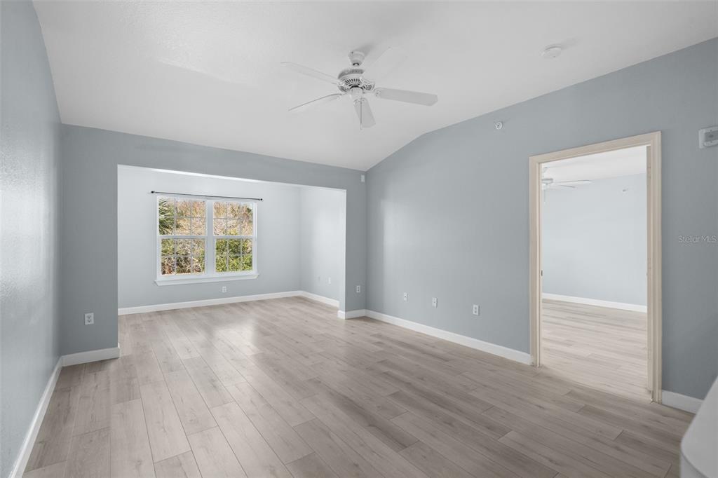 5459 Vineland Road, Unit 4302 Orlando, FL 32811 - Photo 8 of 25 an empty room with wooden floor and windows
