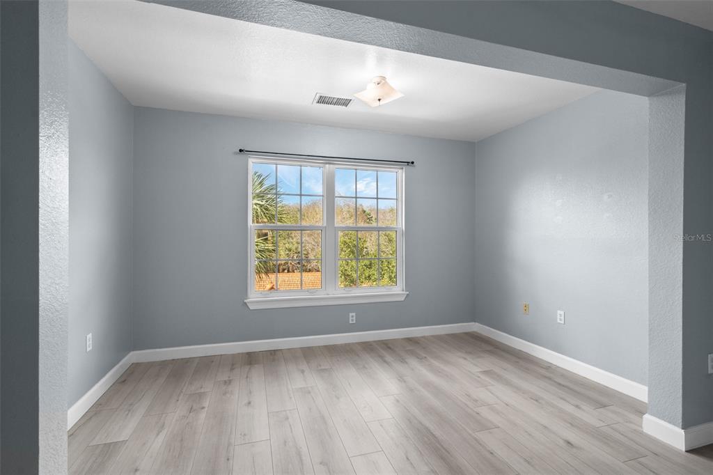 5459 Vineland Road, Unit 4302 Orlando, FL 32811 - Photo 10 of 25 an empty room with wooden floor and windows