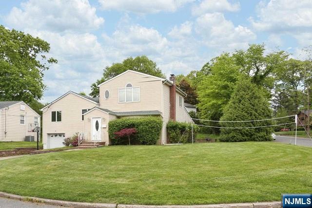 84 12th Street Cresskill, NJ 07626 - Photo 44 of 45 a front view of a house with a garden