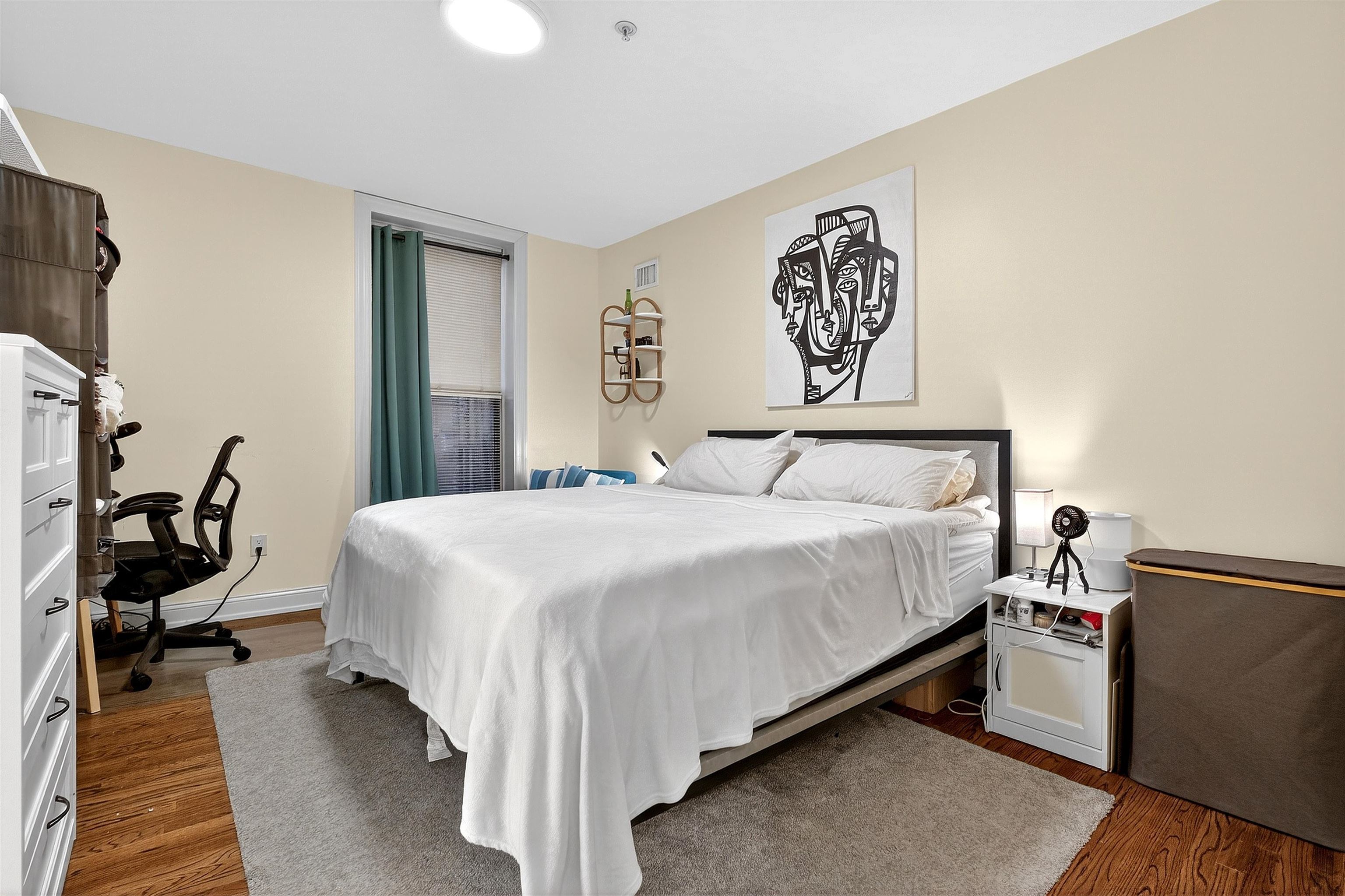 46 Mercer Street, Unit 2 Jersey City, NJ 07302 - Photo 12 of 17 a bedroom with a bed and wooden floor