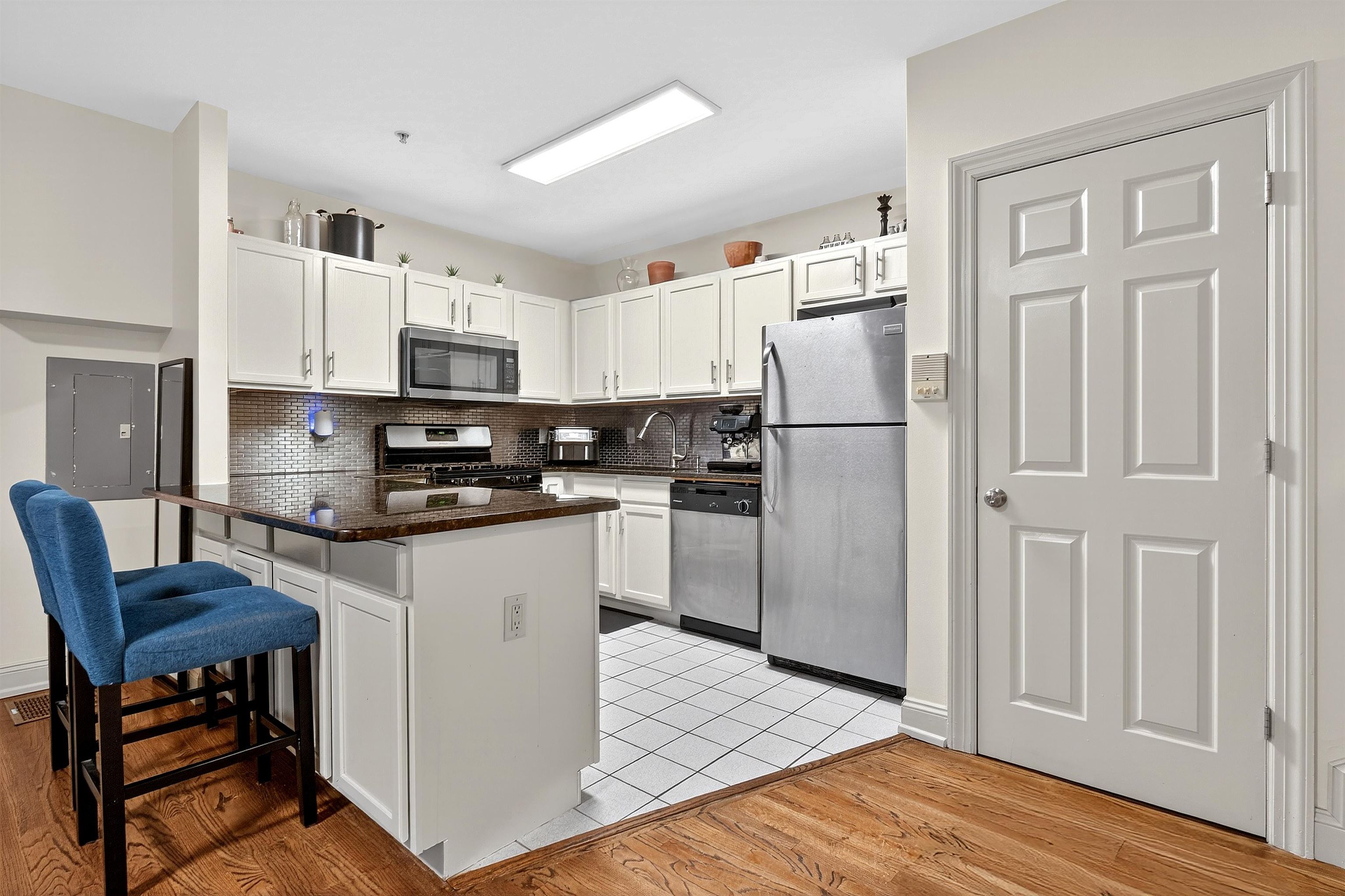 46 Mercer Street, Unit 2 Jersey City, NJ 07302 - Photo 5 of 17 a kitchen with stainless steel appliances granite countertop a refrigerator sink and stove