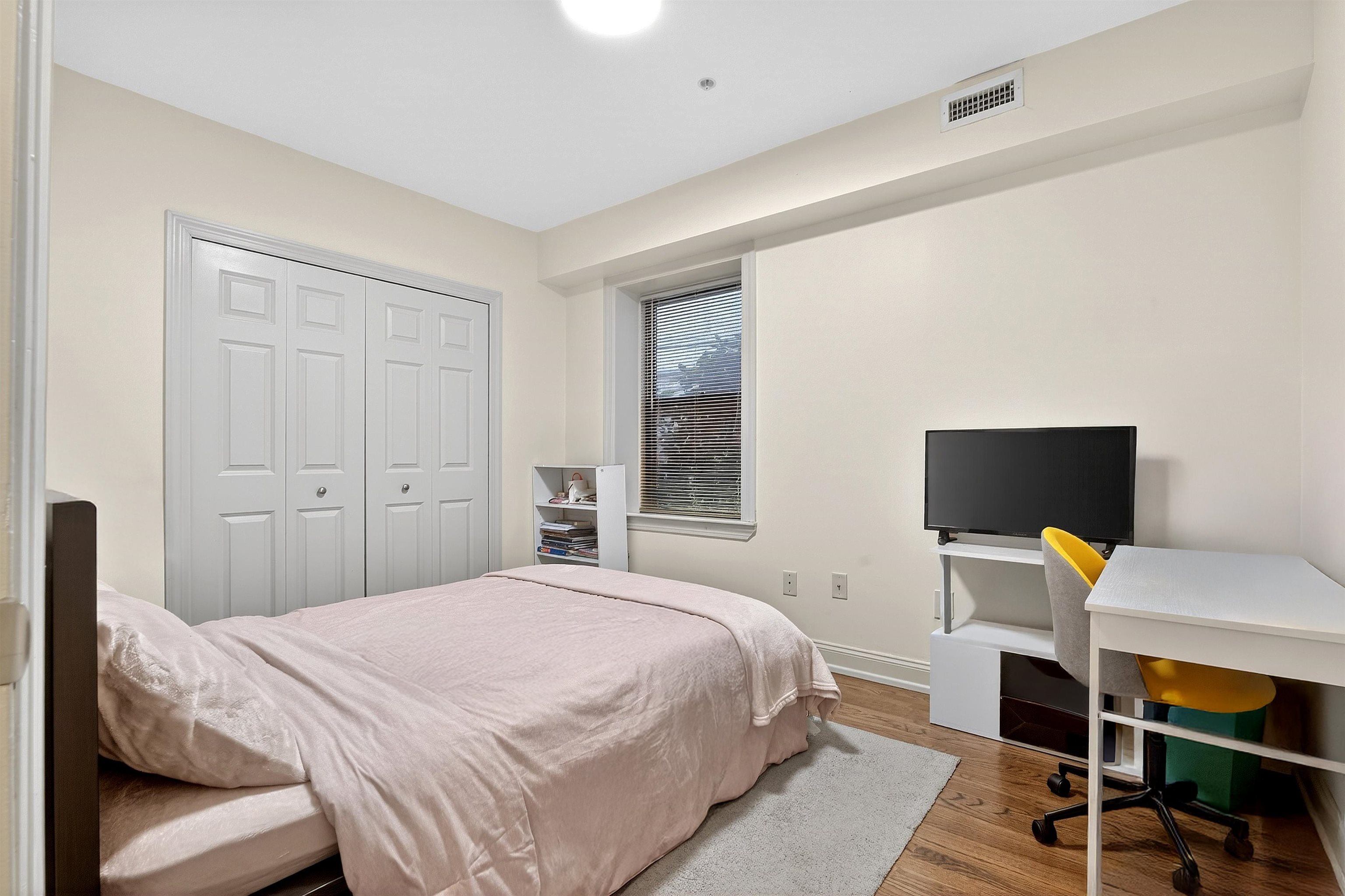 46 Mercer Street, Unit 2 Jersey City, NJ 07302 - Photo 10 of 17 a bedroom with a bed and a desk