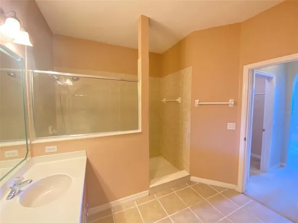 a bathroom with a granite countertop sink a toilet and a mirror