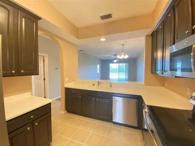 a kitchen with stainless steel appliances granite countertop a sink and a cabinets