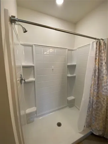 a bathroom with a glass shower door