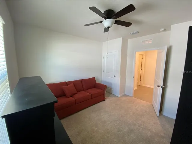 a bedroom with furniture and a window