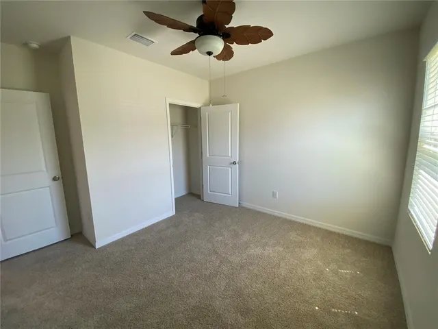 a view of an empty room and a window