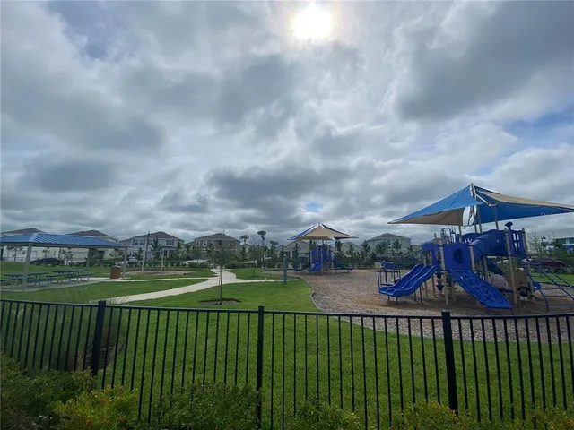 a view of a house with a big yard and a fountain
