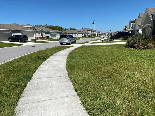a view of a street with a cars park front of the house