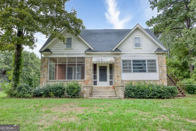 a front view of a house with a garden