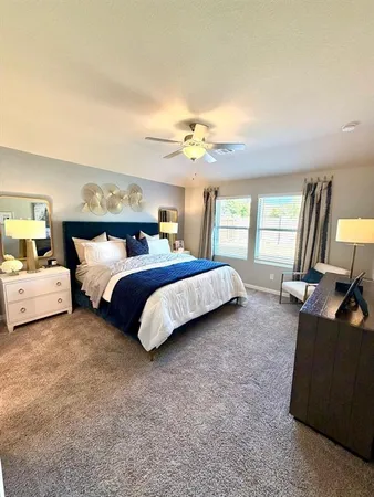a spacious bedroom with a bed and a chandelier