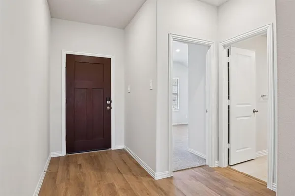 a view of a hallway with wooden floor