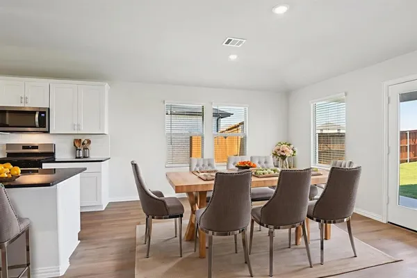 a view of a dining room with furniture and a window