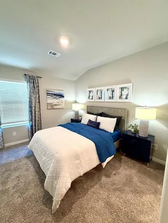 a bedroom with a bed and a night stand