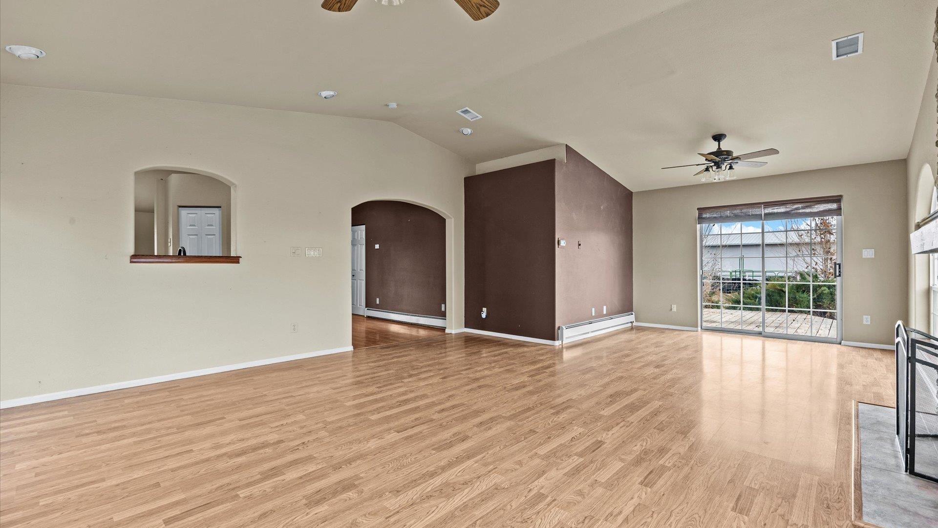 1195-17 1/2 North 1/2 Road Fruita, CO 81521 - Photo 12 of 33 an empty room with wooden floor and windows