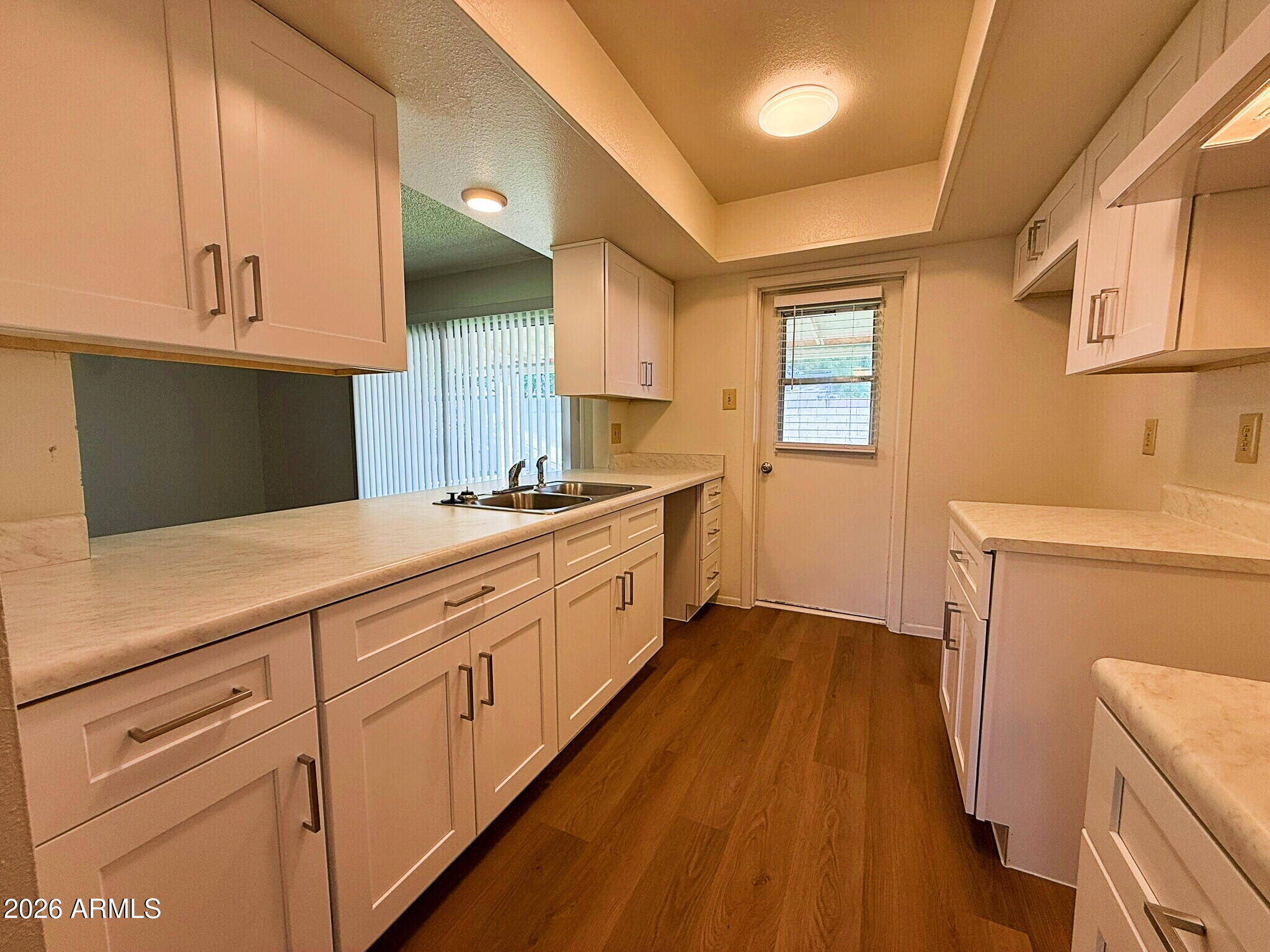 5208 West Calavar Road Glendale, AZ 85306 - Photo 8 of 39 a kitchen with sink cabinets and wooden floor
