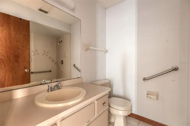 a bathroom with a sink toilet and a mirror