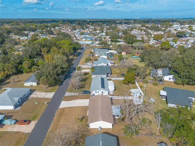 an aerial view of a residential apartment building with a yard