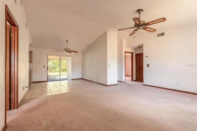 a view of empty room with a ceiling fan