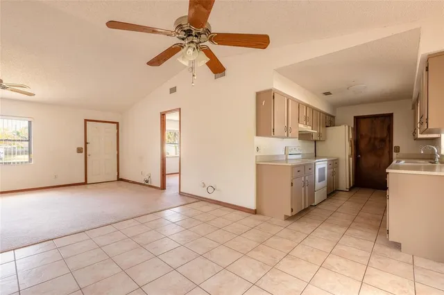 a view of a kitchen with a sink and a stove top oven