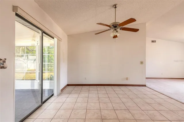 a view of a livingroom with a ceiling fan and window
