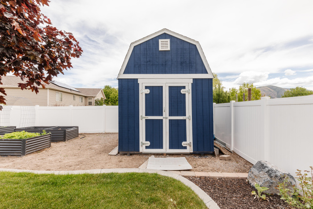 972 West 2840th Street South Logan, UT 84321 - Photo 40 of 46 Barn-style shed with blue siding and white trim
