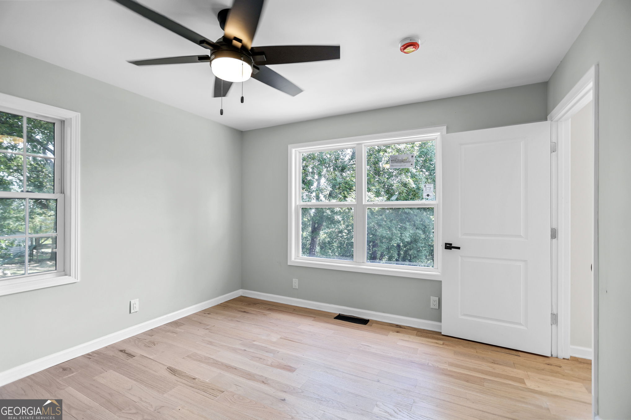 7060 Scenic Heights Road Manchester, GA 31816 - Photo 33 of 52 a view of an empty room with wooden floor and a window