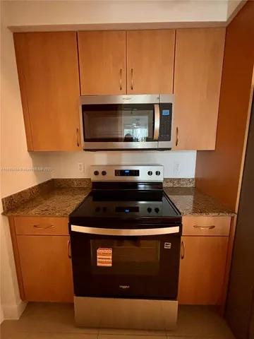 a stove top oven sitting inside of a kitchen
