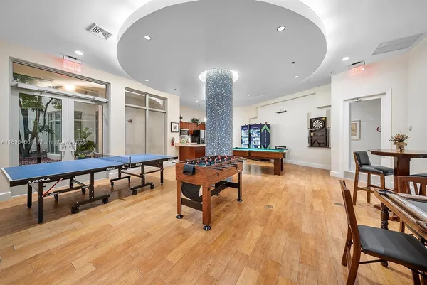 a living room with kitchen furniture and a table
