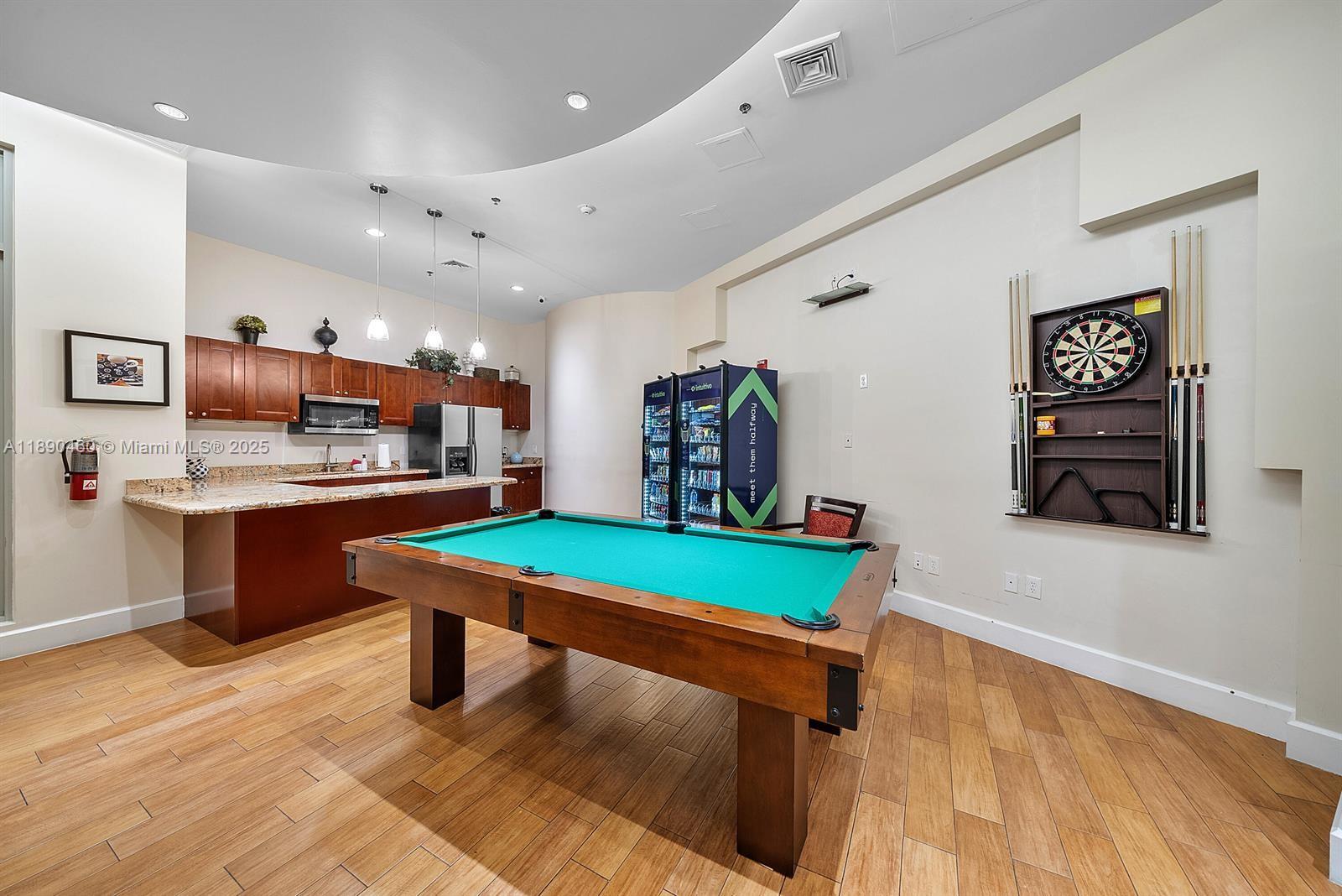 1830 Radius Drive, Unit 318 Hollywood, FL 33020 - Photo 33 of 47 a living room with kitchen furniture and a table