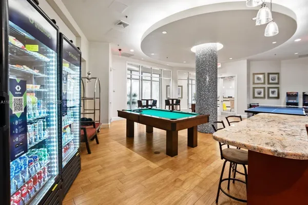 a view of a dining room with furniture a flat screen tv and wooden floor