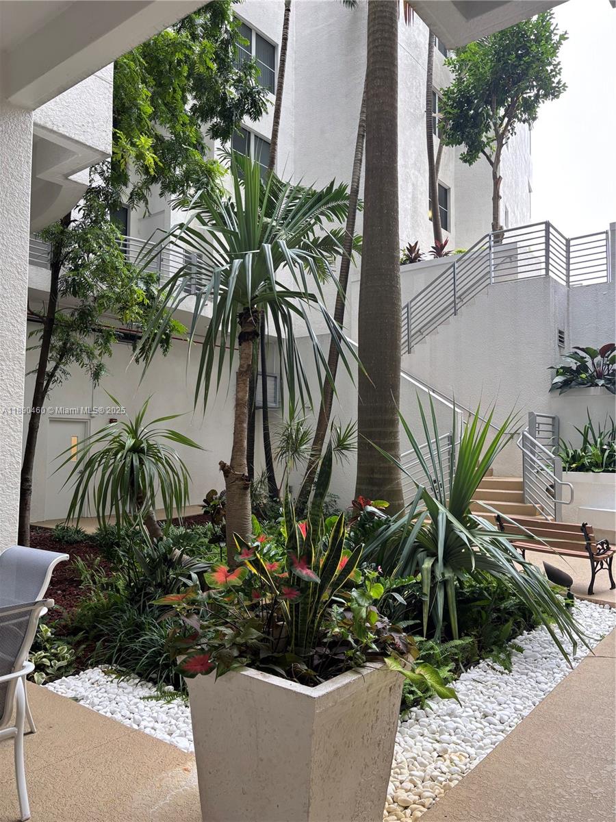 1830 Radius Drive, Unit 318 Hollywood, FL 33020 - Photo 43 of 47 a potted plant sitting in front of a house